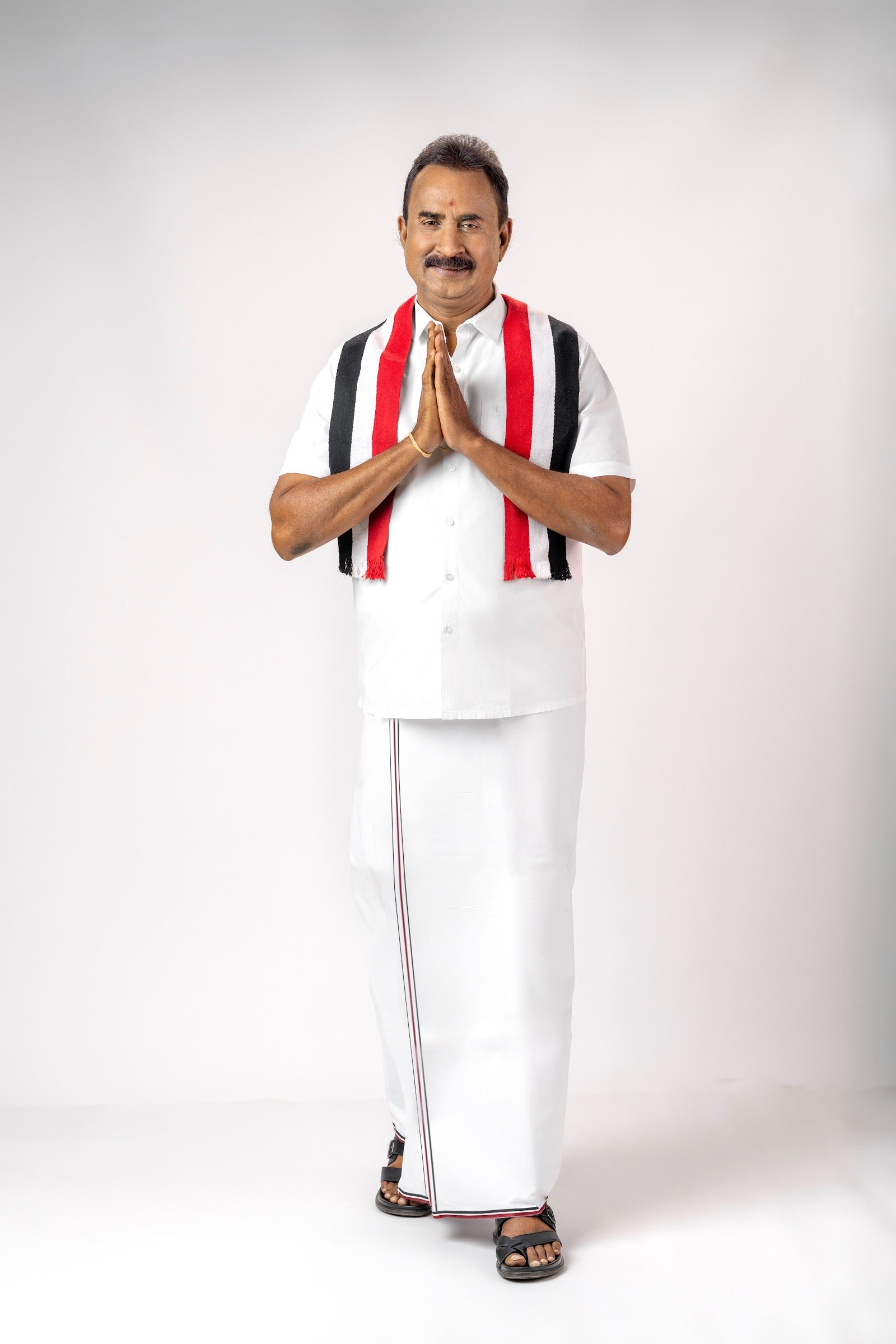 S. P. Velumani greeting in the party colours