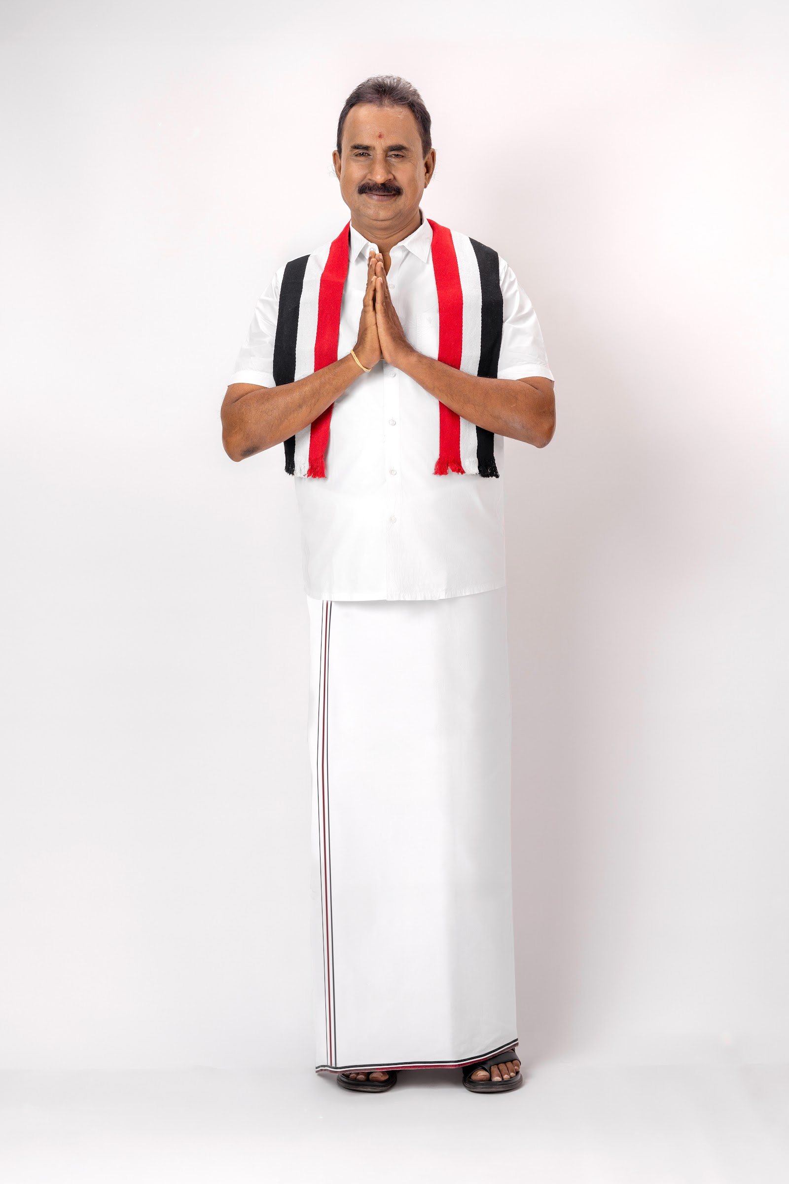 S. P. Velumani greeting in the party scarf
