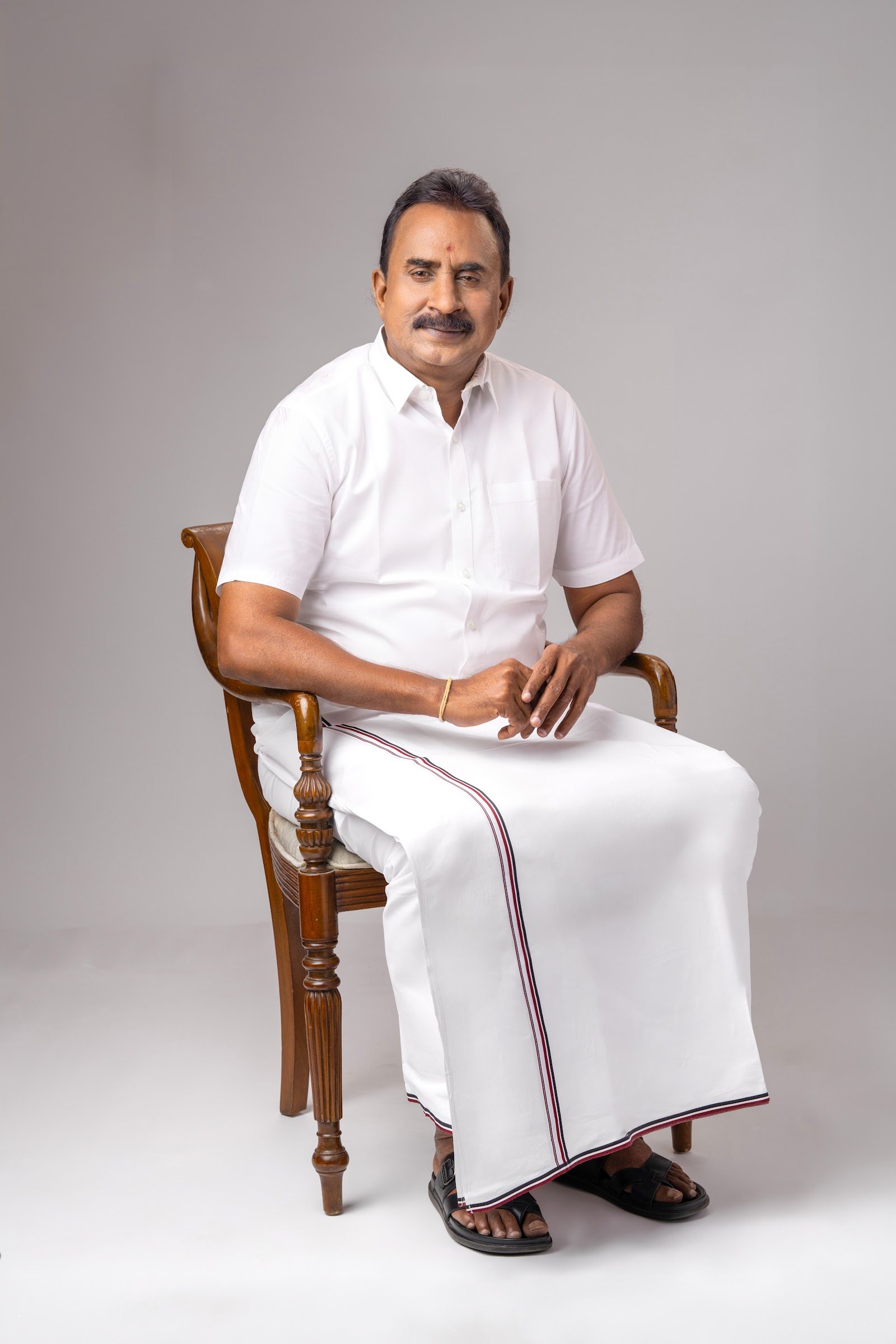 S. P. Velumani seated portrait