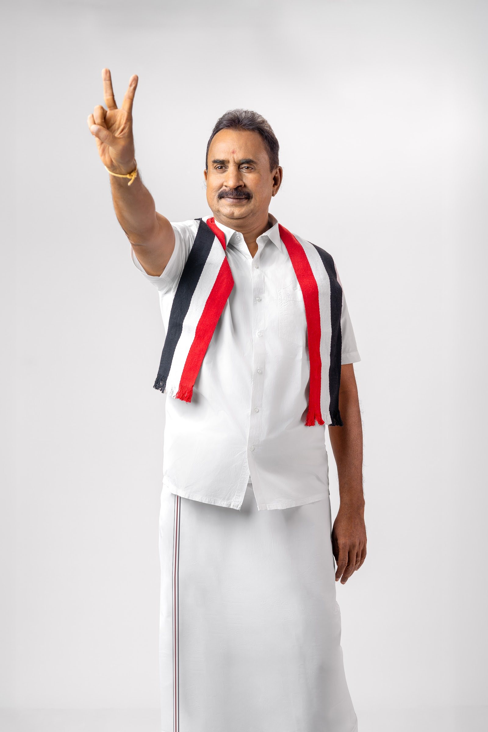 S. P. Velumani raising a victory sign