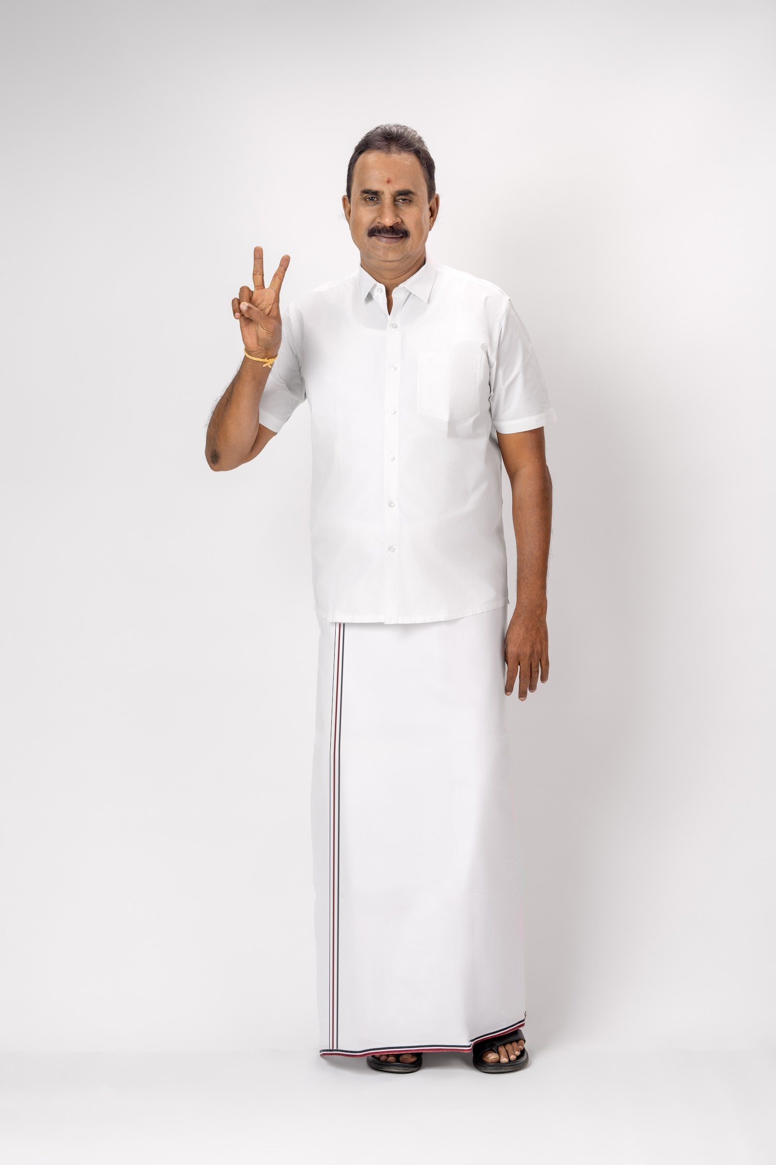S. P. Velumani raising a victory sign