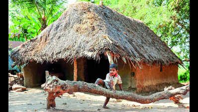 A child outside a thatched hut