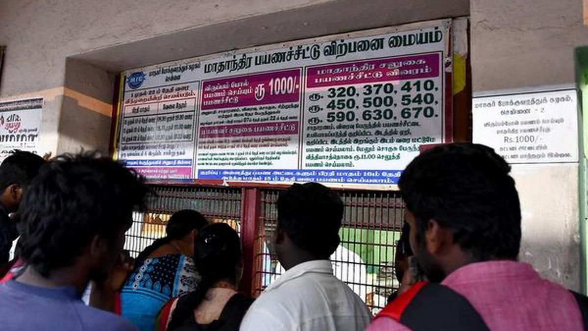 Students reading a notice board outside a government office